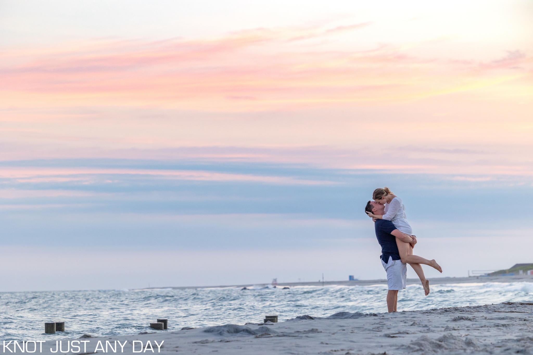 engagement photo of couple on the beach in Cape May, NJ during sunset
